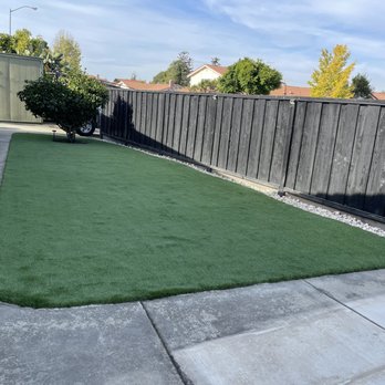 Tran's Landscaping - a backyard with artificial grass - Landscaping Near Me