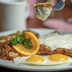 The Biscuit Basket - Chicken Fried Steak with 2 sunny side eggs and home fries