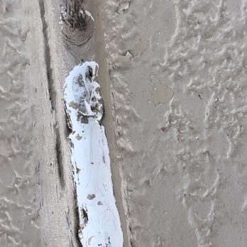 Desert Mesa Painting - Another photo of the wet paint and caulking it between the seams of our driveway a month after it was done - Painters Near Me - El Mirage, Arizona Desert Mesa Painting - Another photo of the wet paint and caulking it between the seams of our driveway a month after it was done - Painters Near Me - El Mirage, Arizona