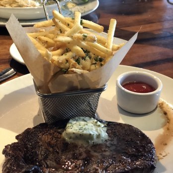 Stoney River - Ribeye Steak with Parmesan Fries (front), Trio Medallions with Potatoes Au Gratin (back) - Steakhouses Near Me - Atlanta, Georgia Stoney River - Ribeye Steak with Parmesan Fries (front), Trio Medallions with Potatoes Au Gratin (back) - Steakhouses Near Me - Atlanta, Georgia