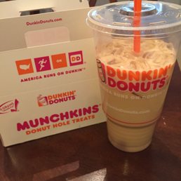  a cup of coffee and a box of donuts