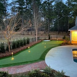 Elite Landscapes - Custom putting green, walkway and landscaped back yard.