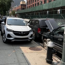 KNR Auto Repairs - Vehicles being stored outside the shop on the sidewalk and completely blocking access to the fire hydrant.