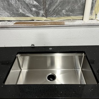 All Wolf Pack Countertops - Stainless Steel Sink and Black Sparkle Material - Countertop Installation Near Me