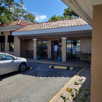 Toasted Mango Cafe - a car parked in front of the restaurant - Cafes Near Me - Sarasota, Florida