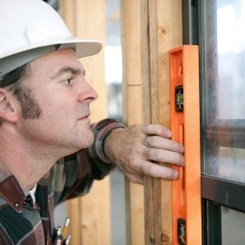 Moms Mobile Screens - a construction worker measuring a window - General Contractors Near Me Moms Mobile Screens - a construction worker measuring a window - General Contractors Near Me