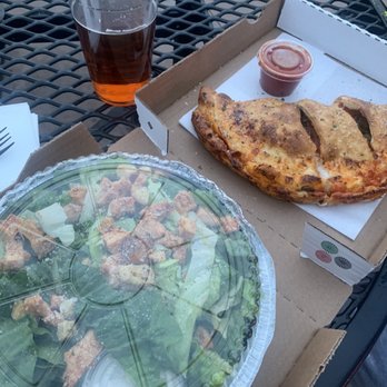 Upland Pizza - a pizza and salad on a table - Pizza Near Me - Upland, California Upland Pizza - a pizza and salad on a table - Pizza Near Me - Upland, California