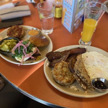 Snooze, an A.M. Eatery - (Right) Classic Snooze Breakfast with hash browns and to the (Left) Double bacon Sammi With hash browns. - Breakfast & Brunch Near Me - Tustin, California Snooze, an A.M. Eatery - (Right) Classic Snooze Breakfast with hash browns and to the (Left) Double bacon Sammi With hash browns. - Breakfast & Brunch Near Me - Tustin, California