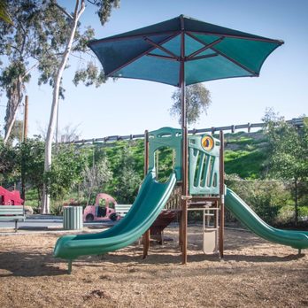 Salazar Landscaping - a children's play area with a slide and umbrella - Landscaping Near Me - South Gate, California Salazar Landscaping - a children's play area with a slide and umbrella - Landscaping Near Me - South Gate, California