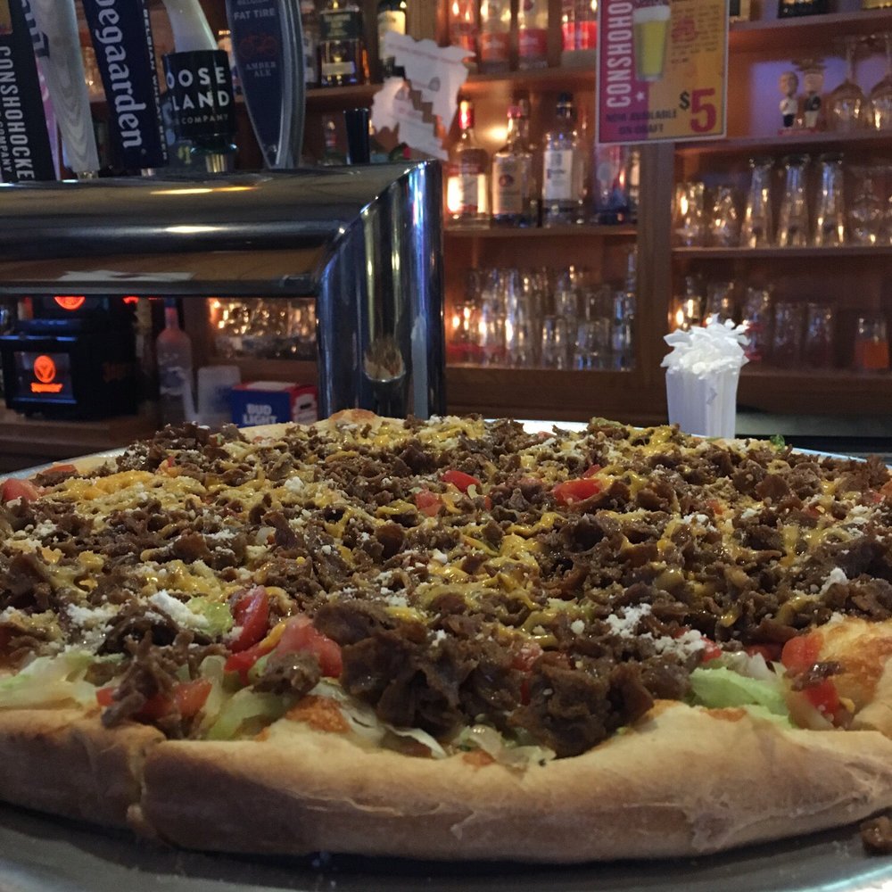 a large pizza on a metal platter
