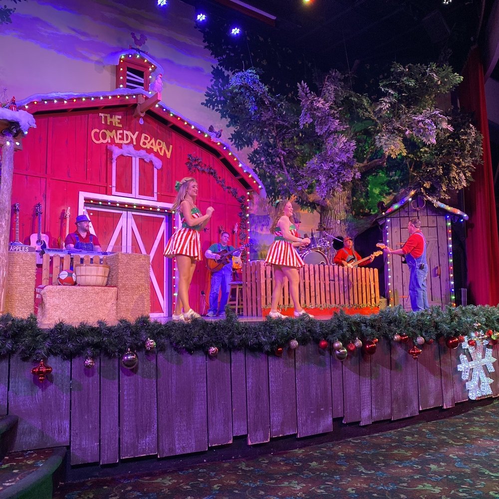 The Comedy Barn Theater - a stage with a barn and people on it - Performing Arts Near Me - Pigeon Forge, Tennessee
