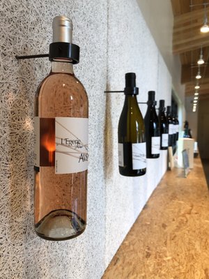 Photo of Avennia - Woodinville, WA, US. bottles of wine lined up on a wall
