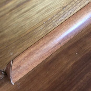 The Design Gallery by Paul Evans - a closeup of the edge of a hardwood floor - Carpeting Near Me - Odessa, Texas The Design Gallery by Paul Evans - a closeup of the edge of a hardwood floor - Carpeting Near Me - Odessa, Texas