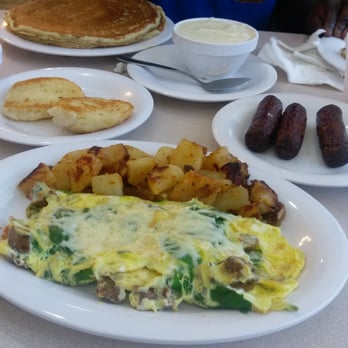 About Time Cafe - Half stack pancakes,biscuit, chicken sausage, spinach,asiago cheese omelette, side of sausage and corn bread grits. - Breakfast & Brunch Near Me - Sunrise, Florida