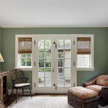 Midnight Magic Construction - a living room with green walls - Roofing Near Me