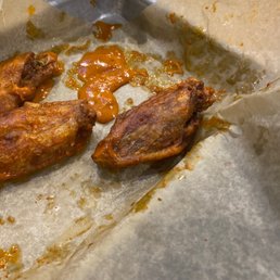 Overcooked chicken wings with barely any sauce.