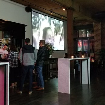 Queer Bar - a group of people sitting at a bar - Gay Bars Near Me - Seattle, Washington