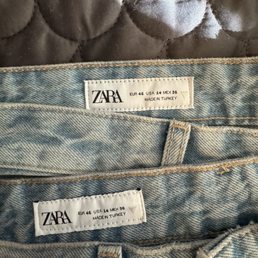 Two pairs of the same jeans labeled the same size, one is incorrect