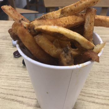 Five Guys - Regular Size Cajun Fries-- plus a handful in the bag that were overflowing the cup - Burgers Near Me - San Antonio, Texas