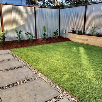 Kestrel Landscapes - a backyard with artificial grass - Landscaping Near Me