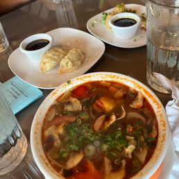 tom yom soup and half eaten appetizers