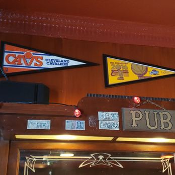 Academy Tavern - a bar with a clock and pennants on the wall - Bars Near Me - Cleveland, Ohio