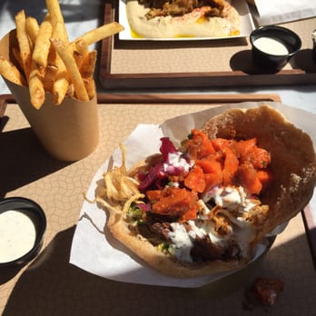 Brassica - Pita sandwich and basket of fries. - Mediterranean Near Me - Columbus, Ohio Brassica - Pita sandwich and basket of fries. - Mediterranean Near Me - Columbus, Ohio