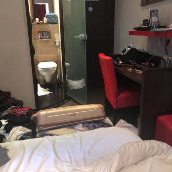Apollo Museumhotel Amsterdam City Centre - View sitting on furthest bed. Front door and bathroom with luggage on entire floor - Hotels Near Me - Amsterdam, New Hampshire