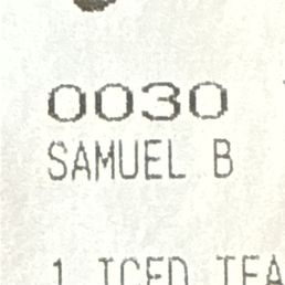 A close-up image of a printed label displaying the name 'SAMUEL B' and the number '0030', with additional text partially visible.