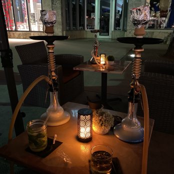 Groovy's - a table with a hooket and a glass of water - Pizza Near Me - Miami Beach, Florida