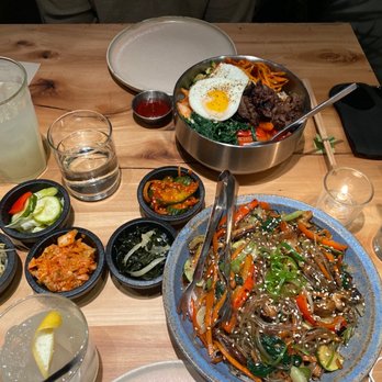 Oseyo - yuzu lemonade and cocktail, beef bibimbap, and Ddak Gui - grilled chicken thigh japchae. Also included was a side spread of kimchi and more - Korean Near Me - Austin, Texas Oseyo - yuzu lemonade and cocktail, beef bibimbap, and Ddak Gui - grilled chicken thigh japchae. Also included was a side spread of kimchi and more - Korean Near Me - Austin, Texas