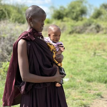 Bush Signature - Maasai woman and baby (I think her grandchild) - Tours Near Me Bush Signature - Maasai woman and baby (I think her grandchild) - Tours Near Me