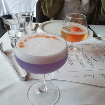 Glowbal - Empress martini (foreground) and the illusionist (background) - Canadian (New) Near Me - Vancouver, British Columbia Glowbal - Empress martini (foreground) and the illusionist (background) - Canadian (New) Near Me - Vancouver, British Columbia