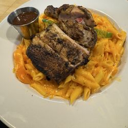 Jerk chicken pasta with barbecue sauce on the side