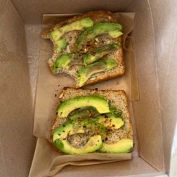 two halves of avocado toast in a box two halves of avocado toast in a box