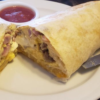 Orange Cafe Bistro - Monster breakfast burrito! Eggs, ham, sausage, cheese, hash brown, sour cream, salsa & Avocado on the side! - Breakfast & Brunch Near Me - Orange, California