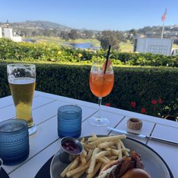 Aperol, beer, burger; outdoor view. Aperol, beer, burger; outdoor view.