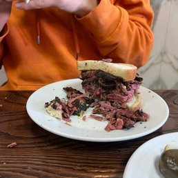 Only half of the enormous Pastrami sandwich Only half of the enormous Pastrami sandwich