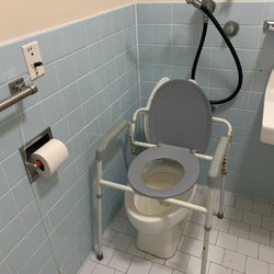 Wave Crest Health and Rehabilitation Center - Regular toilet, not handicap. No grab bar. Notice the commode legs.... They only had that one available.
