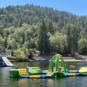 Lake Gregory Regional Park - Kids section and 2 of the slides at inflatable water park with the built in slide in the background. - Hiking Near Me - Crestline, California Lake Gregory Regional Park - Kids section and 2 of the slides at inflatable water park with the built in slide in the background. - Hiking Near Me - Crestline, California