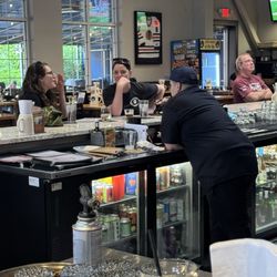 Bartender paying attention to women instead of all customers.
