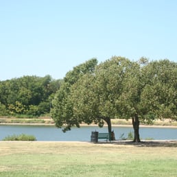 Bench in the shade by the lake.