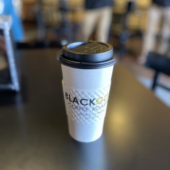 Black Gold Coffee Roasters - a coffee cup on a table - Coffee & Tea Near Me - Venice, Florida Black Gold Coffee Roasters - a coffee cup on a table - Coffee & Tea Near Me - Venice, Florida