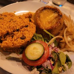 Pastelon Sweet plantain stuffed with ground beef and topped with cheese.