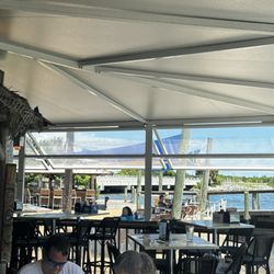 The Island Waterfront Bar & Grill - Left is part of the bar on the patio. Straight out is the patio seating and outside beach area with a bar and dock part to the restaurant
