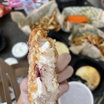 Wingstop - a person holding a piece of food - Chicken Wings Near Me - Gilroy, California Wingstop - a person holding a piece of food - Chicken Wings Near Me - Gilroy, California