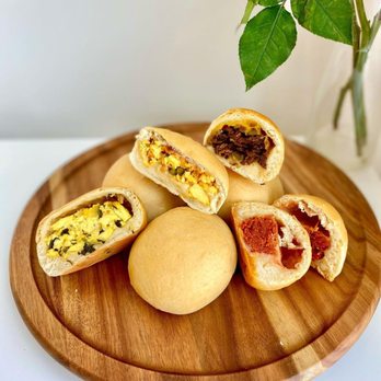 Kolache Factory - a pile of bread rolls on a wooden plate - Breakfast & Brunch Near Me - Frisco, Texas Kolache Factory - a pile of bread rolls on a wooden plate - Breakfast & Brunch Near Me - Frisco, Texas
