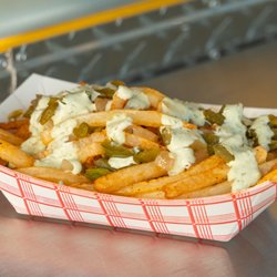 Chock Full of Cheese - Papas Chilosos: Fresh cut fries topped with grilled onions, jalapenos and a homemade spicy jalapeno ranch sauce.