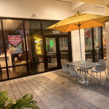 GoPho - the outside of a restaurant with tables and umbrellas - Vietnamese Near Me - Davie, Florida