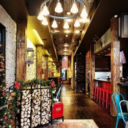 Kbg Welding - Custom host stand and firewood rack wall(back right) for Liberty Barbecue in downtown round rock, Texas